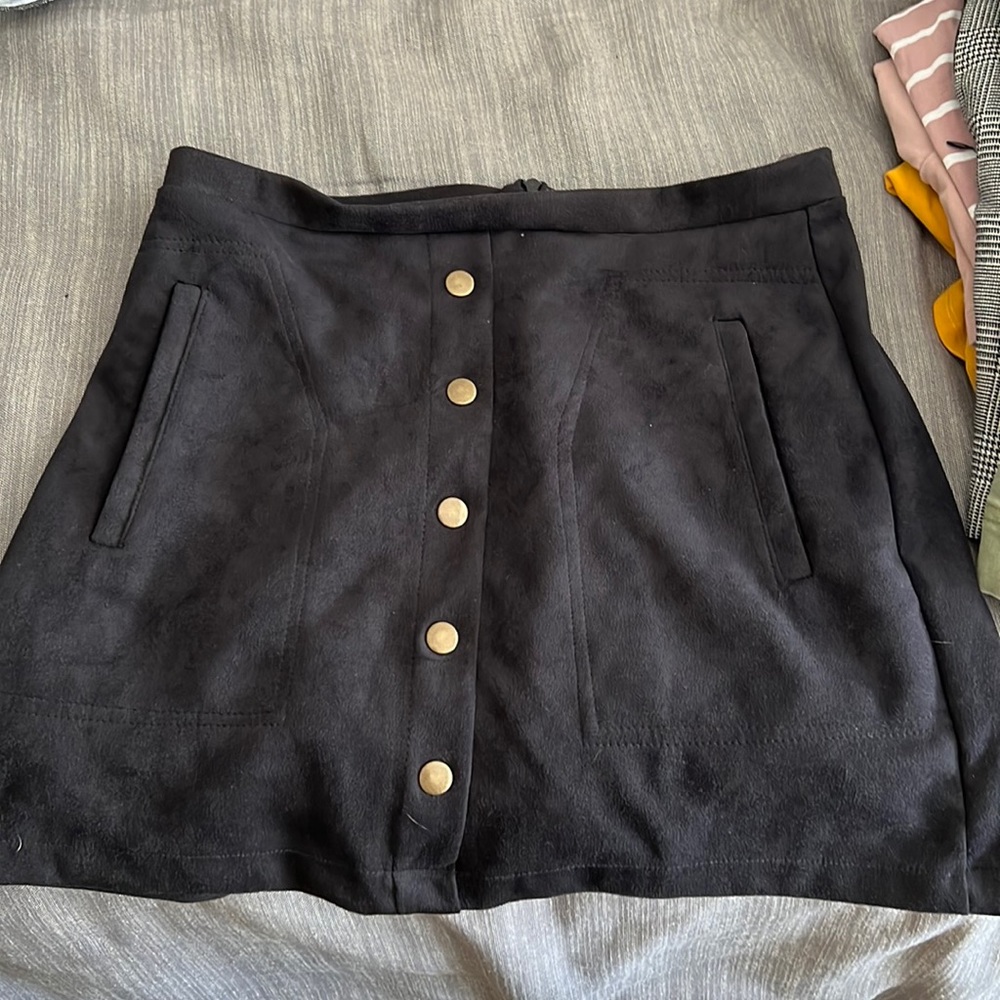 Black, suede skirt with pockets, and gold-ish buttons